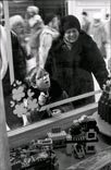 A boy looks at Lego objects in a GUM shop window