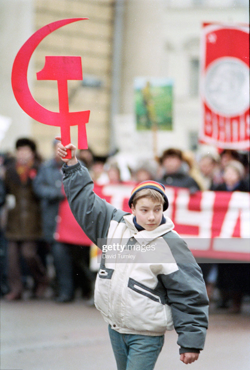 Boy Holding a Soviet Hammer and Sickle Symbol (Мальчик с советскими символами), 1990s