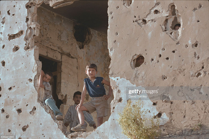 Boy Standing by a Destroyed Wall (Дети у разрушенной стены), 1996