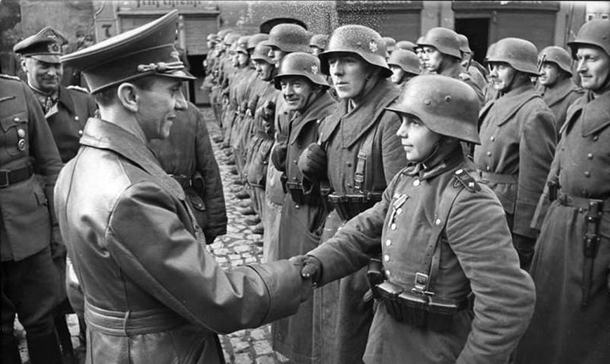 Goebbels awarding a child (Willi Huebner) the Iron Cross, 1945