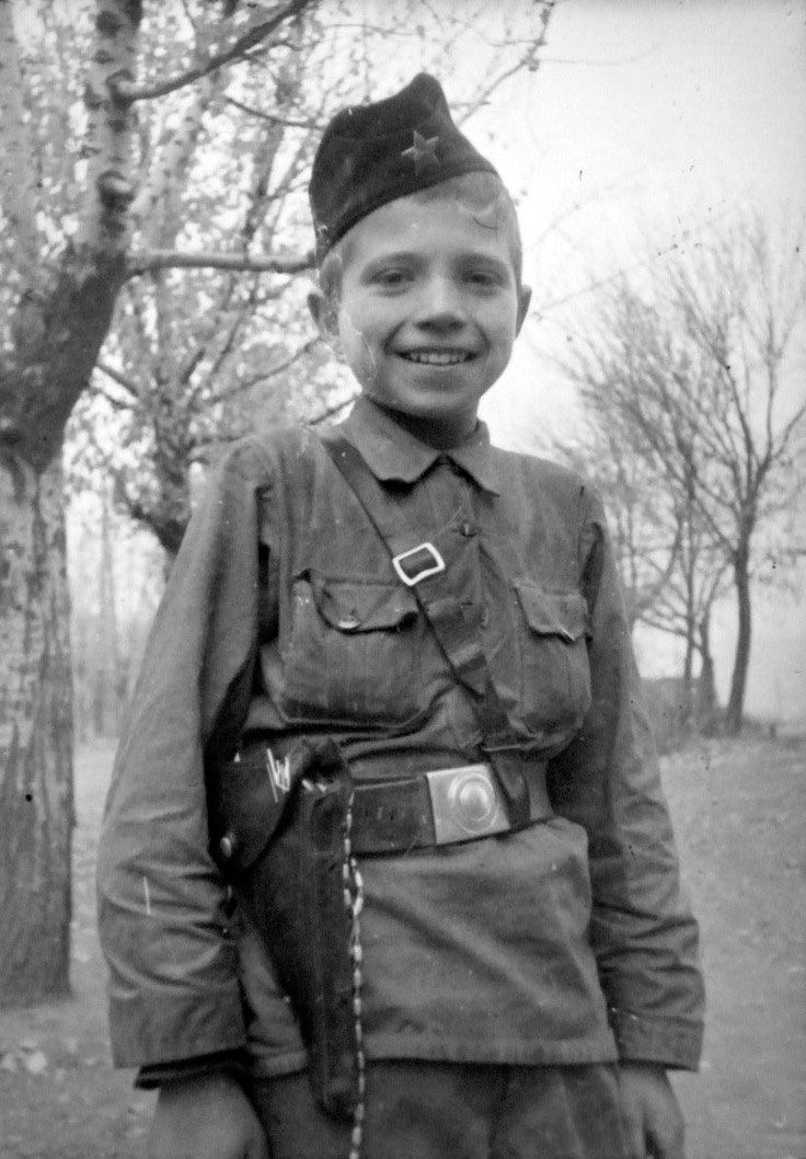 Ten-year old Partizan scout of the Chernigov detachment «For the Motherland» Vasily Borovik on a background of tree, c.1943