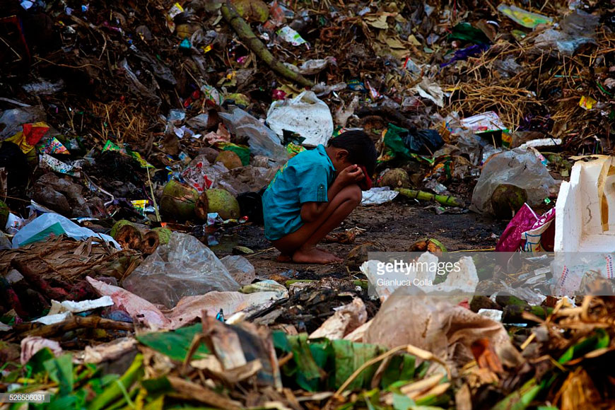 A boy defecating between stacks of garbage (Мальчик, какающи между куч мусора), 2012