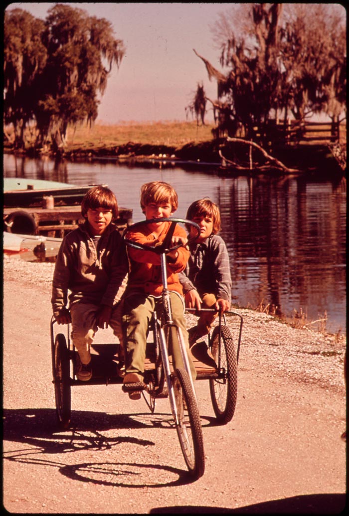 Children of fishermen on homemade tricycle (Дети рыбаков на самодельном трицикле), February 1943