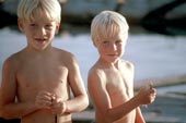 Young boys holding small fish