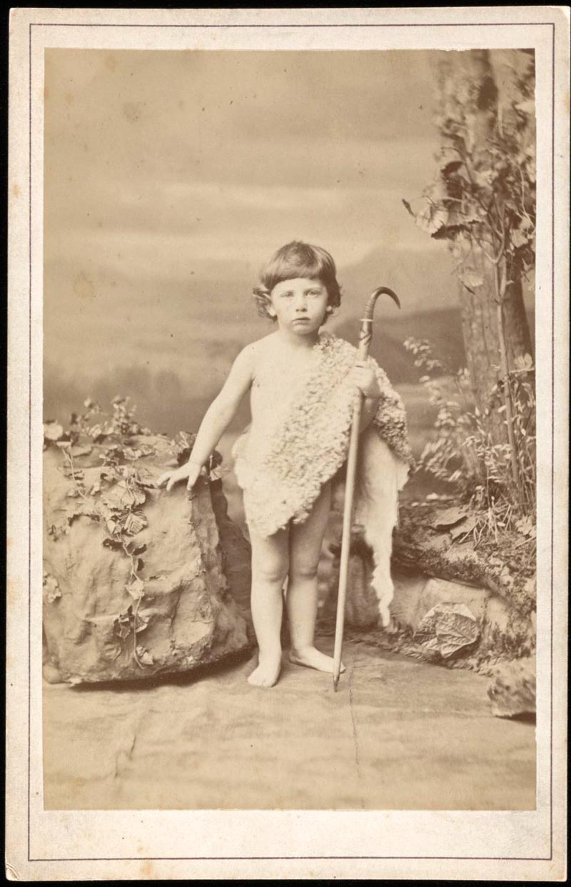 Photograph of Edmund von Motesiczky as a child standing by a boulder dressed in a sheepskin toga holding a shepherd’s crook (Фотография Эдмунда фон Мотезички в детстве, стоящего у валуна, одетого в тогу из овчины и держащего пастуший посох), c.1870